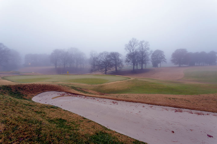 Bunker sand pit trap at a Virginia golf course on a foggy day