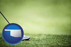 oklahoma map icon and a golf ball and a golf club on a golf course