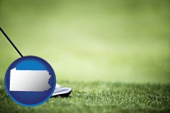 pennsylvania map icon and a golf ball and a golf club on a golf course